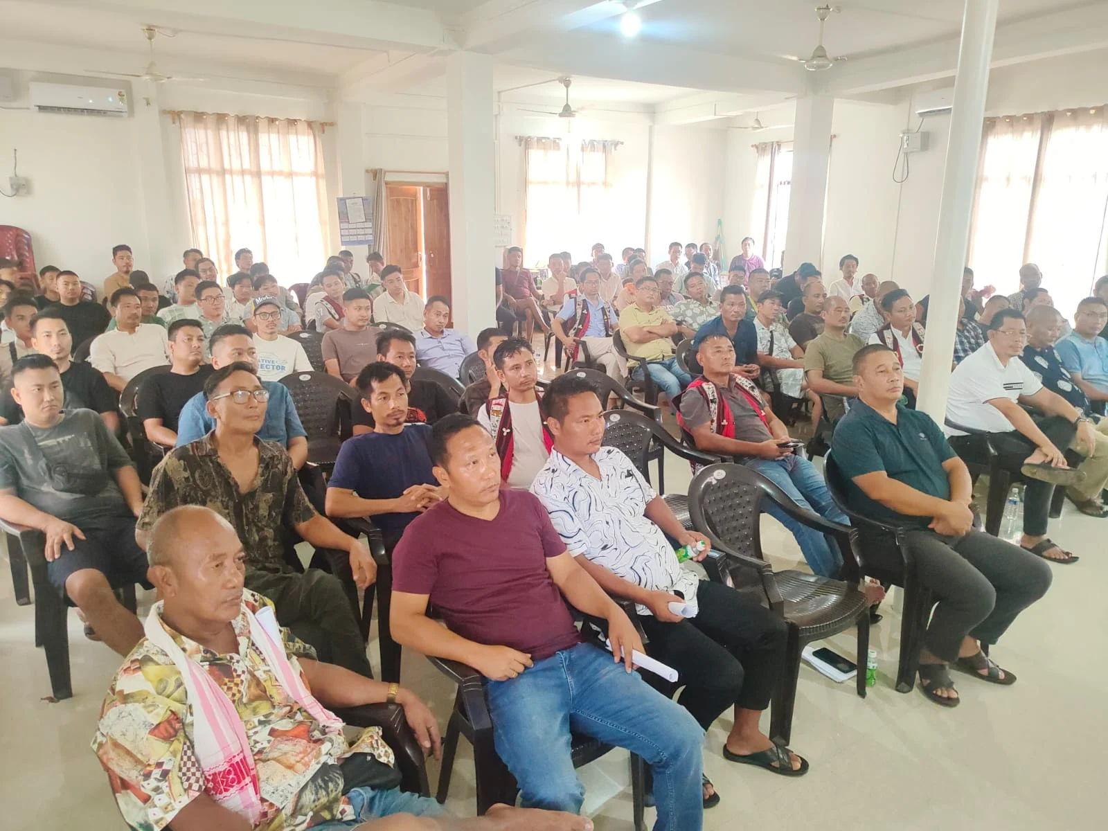 Community members attending a meeting in a local hall
