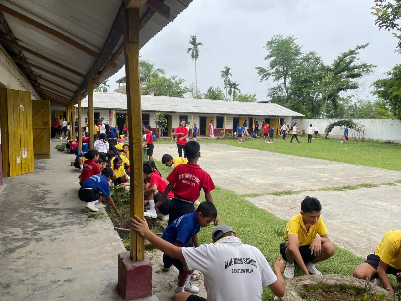Students taking part in a school grounds activity at Blue Moon School